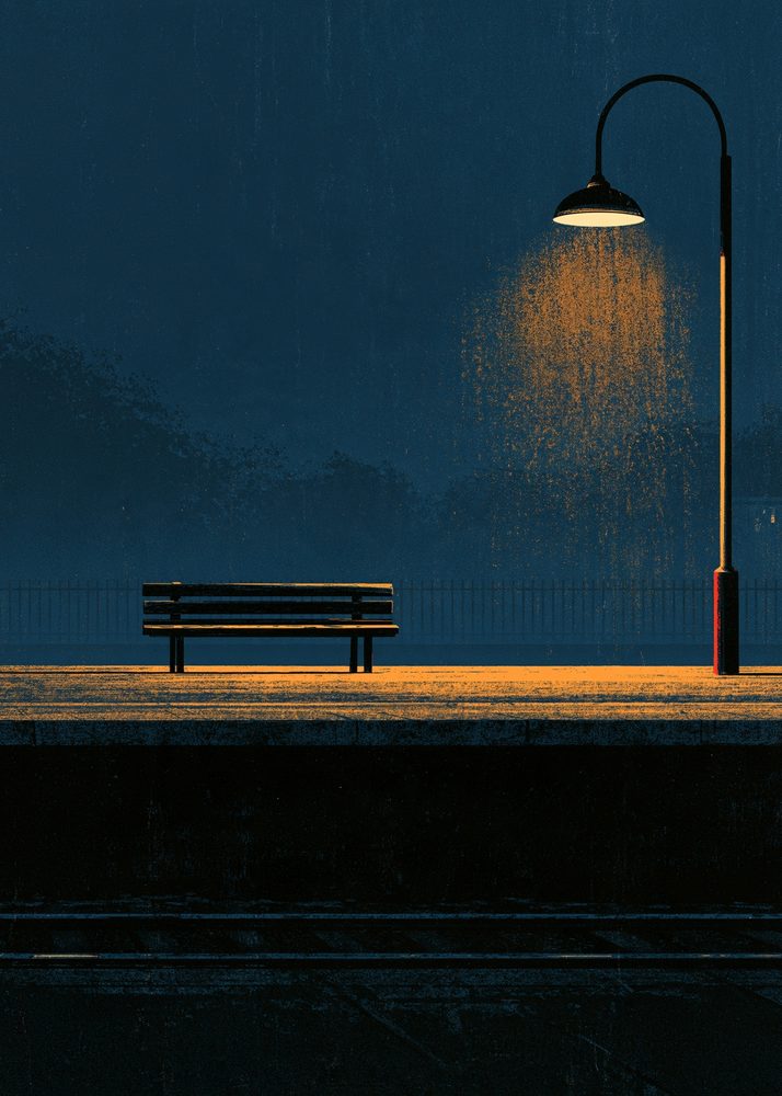 An empty train platform under a lamp at night